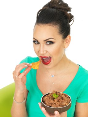 Beautiful Young Attractive Hispanic Woman With Mexican Style Refried Spicy Beans