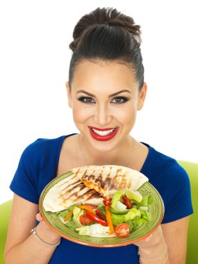 Beautiful Young Attractive Hispanic Woman Holding A Plate of Mexican Quesadula