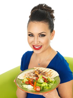 Beautiful Young Attractive Hispanic Woman Holding A Plate of Mexican Quesadula
