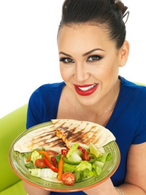Beautiful Young Attractive Hispanic Woman Holding A Plate of Mexican Quesadula