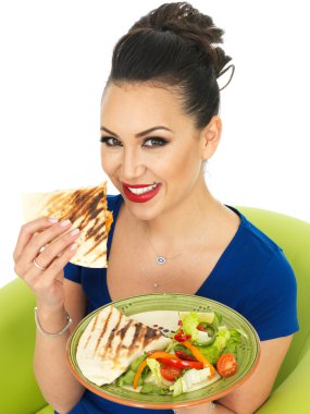Beautiful Young Attractive Hispanic Woman Holding A Plate of Mexican Quesadula