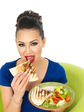 Beautiful Young Attractive Hispanic Woman Holding A Plate of Mexican Quesadula