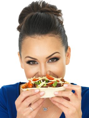 Beautiful Attractive Young Hispnanic Woman Enjoying A Soft Chilli Beef Taco With Salad