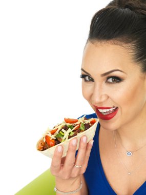 Beautiful Attractive Young Hispnanic Woman Enjoying A Soft Chilli Beef Taco With Salad