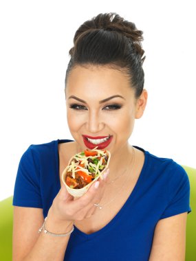 Beautiful Attractive Young Hispnanic Woman Enjoying A Soft Chilli Beef Taco With Salad