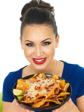 Beautiful Attractive Young Hispanic Woman Holding A Dish of Nachoes