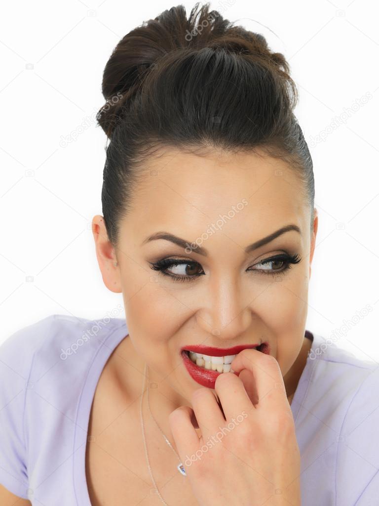 Portrait Of A Beautiful Young Nervous Hispanic Woman Biting Her Finger Nails