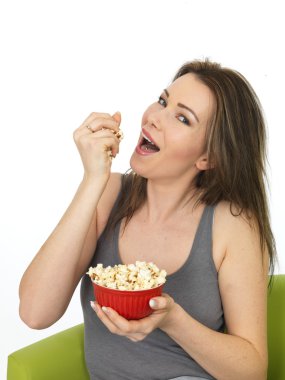 Attractive Young Woman Eating and Enjoying Popcorn