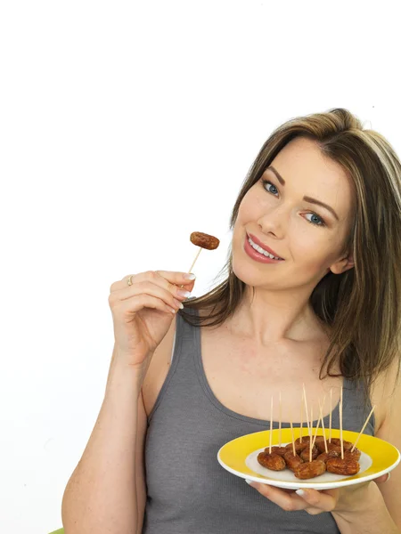 Attractive Young Woman Holding a Plate of Cocktail Sausages — Stock Photo, Image