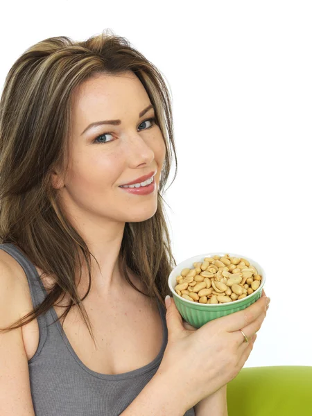 Attractive Young Woman Holding a Bowl of Salted Peanuts — Stock Photo, Image