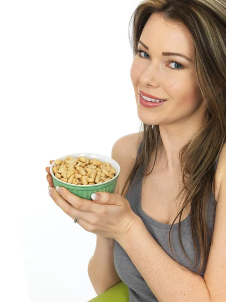 Attractive Young Woman Holding a Bowl of Salted Peanuts — Stock Photo, Image