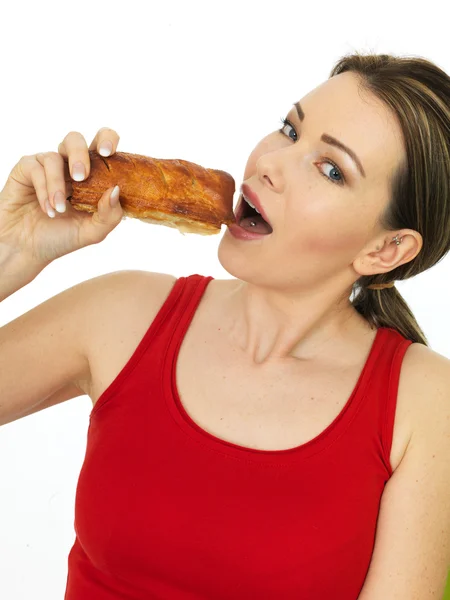 Attractive Young Woman Holding a Cooked Hot Savory Sausage Roll — Stock Photo, Image