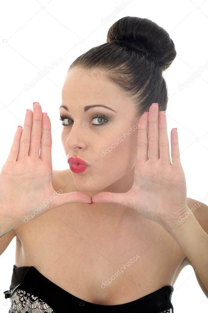 Young Woman Framing Her Face With Her Hands Looking Happy and Pleased