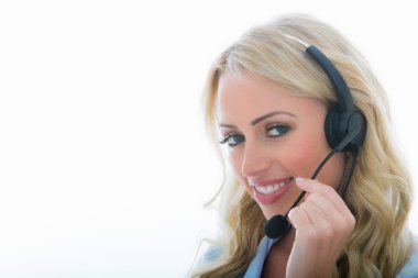 Attractive Young Business Woman Using a Telephone Headset