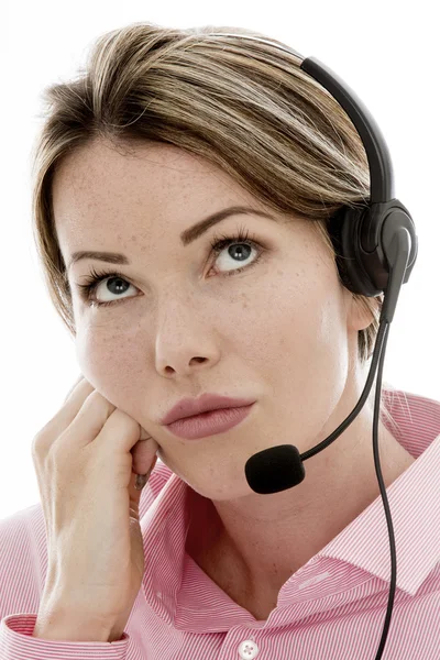 Atractiva joven aburrida mujer de negocios usando un auricular telefónico —  Fotos de Stock