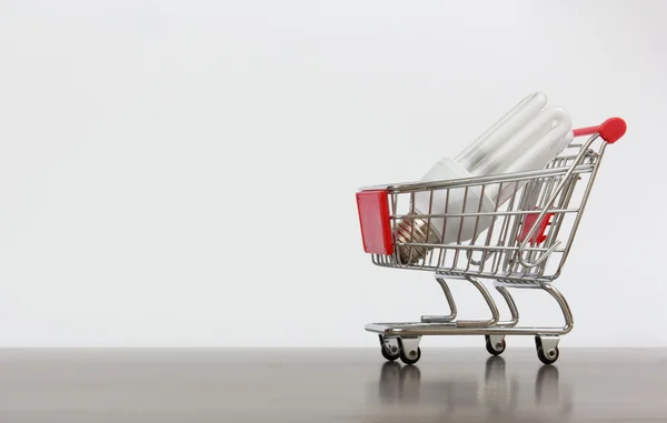 Shopping cart with saving lamp — Stock Photo, Image