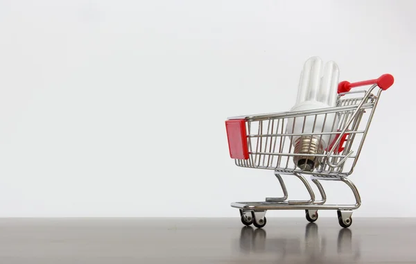 Shopping cart with saving lamp — Stock Photo, Image
