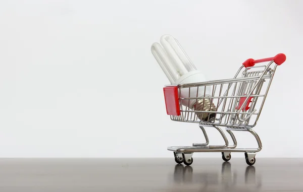 Shopping cart with saving lamp — Stock Photo, Image