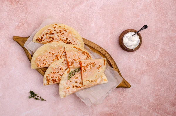 Baked bread with vegetable filling on a stone background. Selective focus.