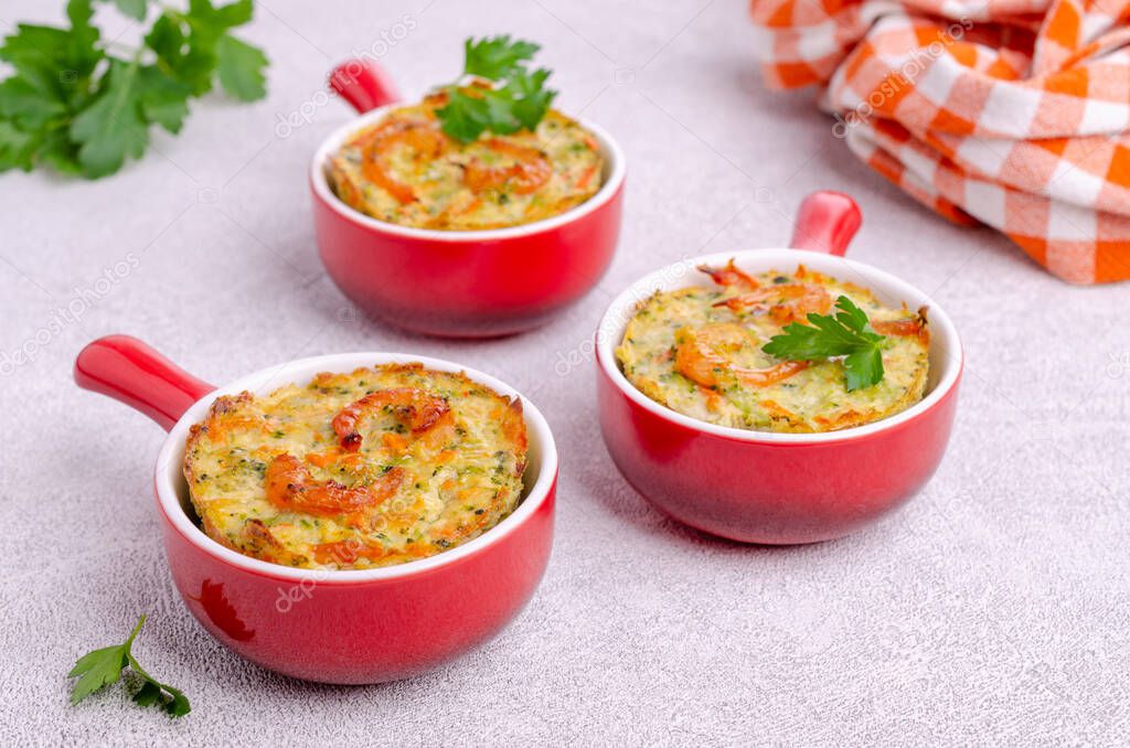 Vegetable muffins with shrimp on a light gray background. Selective focus.