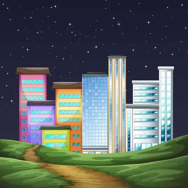 Parque y edificios en la ciudad por la noche — Vector de stock