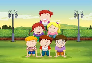 Çocuklar parkta insan piramit yapıyor