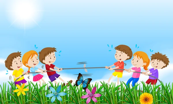 Children playing tug o war in the field