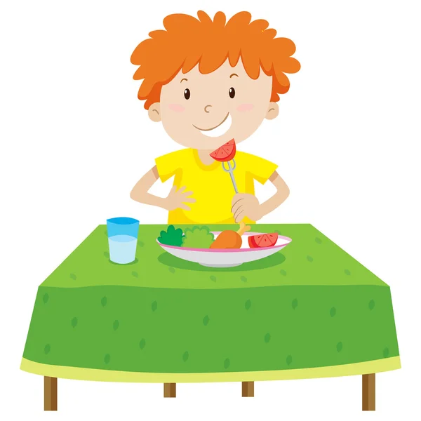 Маленький хлопчик їсть на столі — стоковий вектор