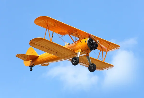 Yellow biplane on the blue sky. — Stock Photo, Image