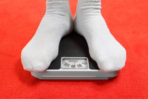 Overweight man standing on weighing machine — Stock Photo, Image