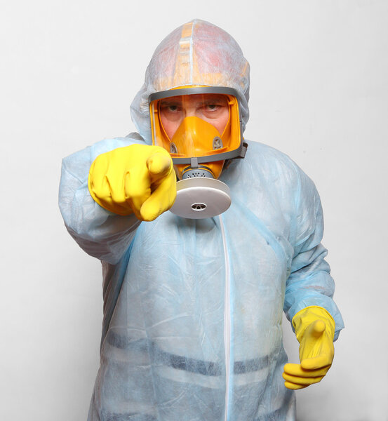 Man in protective clothing with respirator.