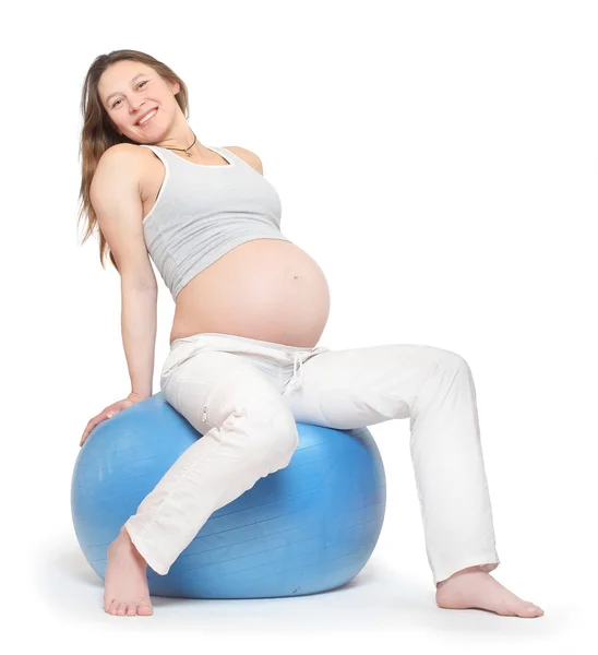 Gravid kvinna utövar på blå boll — Stockfoto