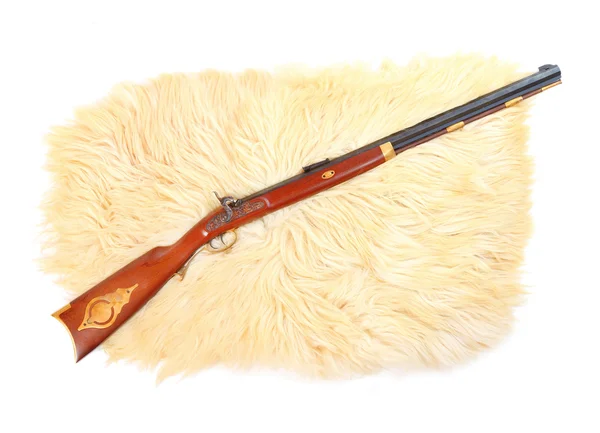 Hunting gun on a sheep fur. — Stock Photo, Image