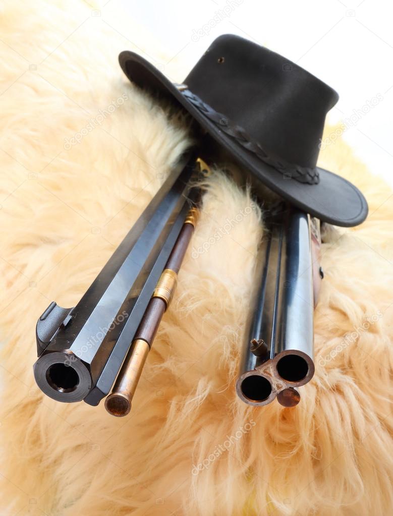 Cowboy hat and hunting guns
