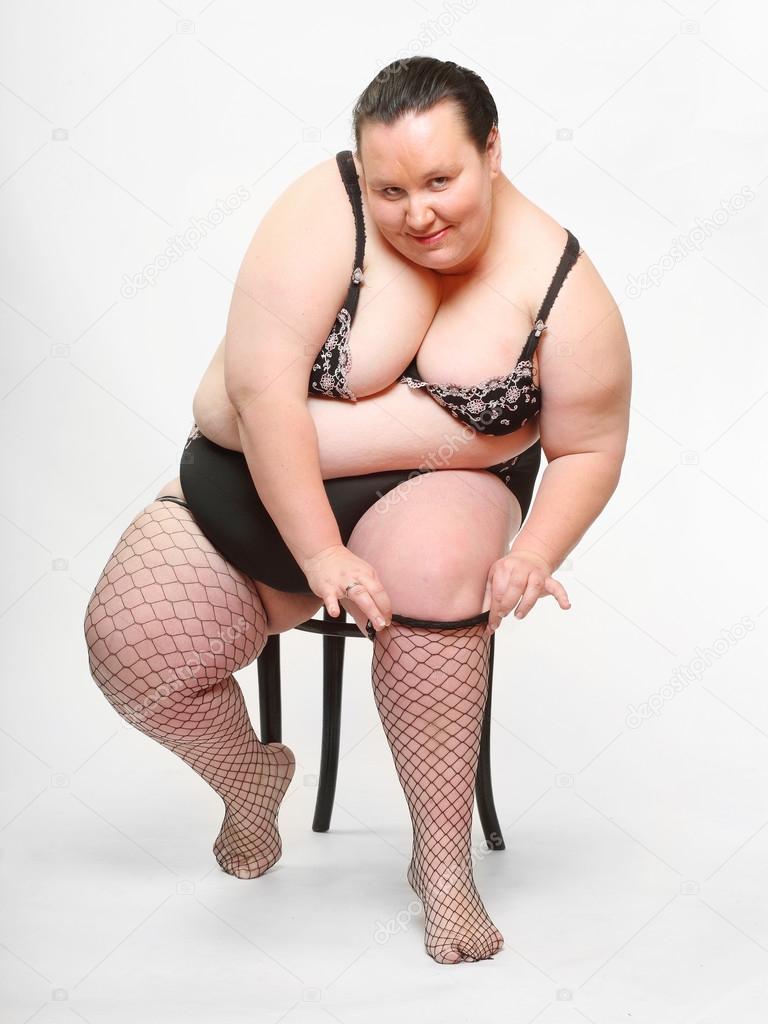 Overweight woman striping down her stockings