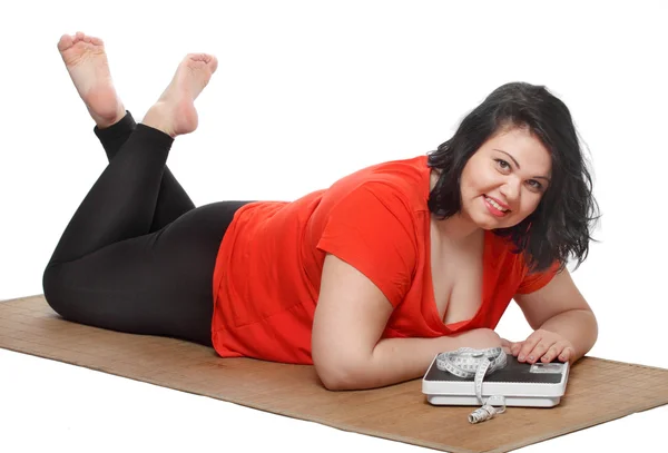 Overweight woman with measure tape and weighing machine — Stock Photo, Image