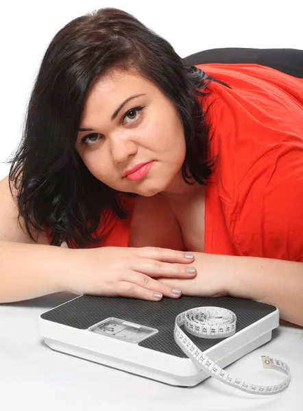 Overweight woman with measure tape and weighing machine — Stock Photo, Image