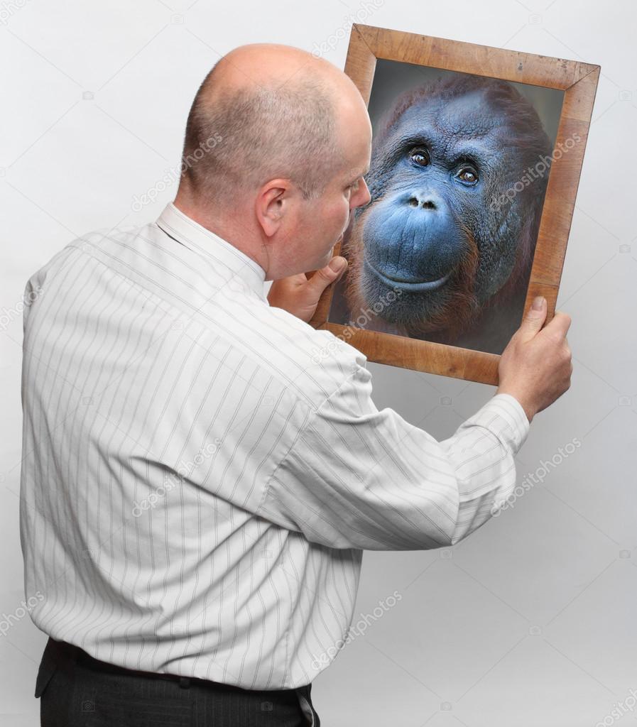 Funny man and mirror with his monkey face