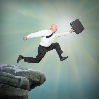 Senior businessman jumping from a edge of cliff