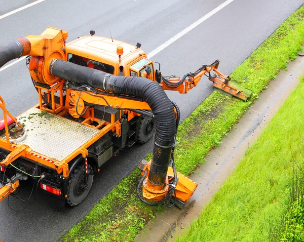 Maintenance on the highway mowing the lawn. — Stock Photo, Image