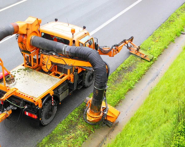 Maintenance on the highway mowing the lawn. — Stock Photo, Image