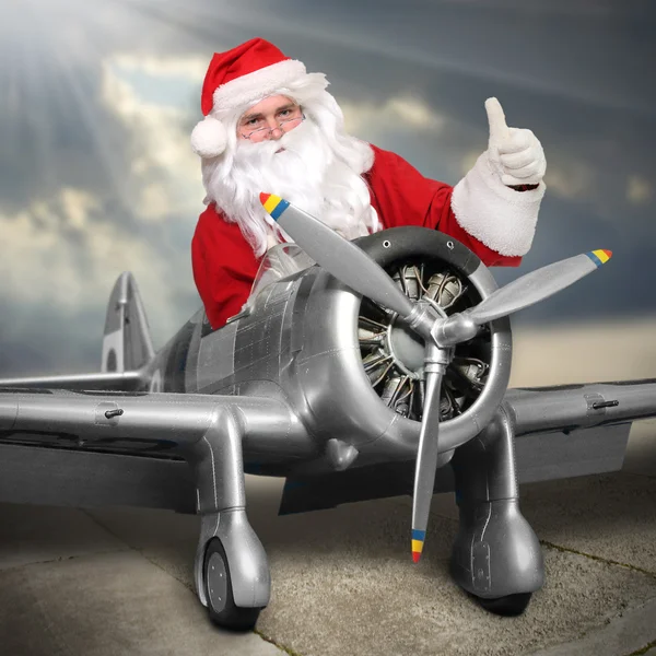 Jultomte med sin last flygplan — Stockfoto