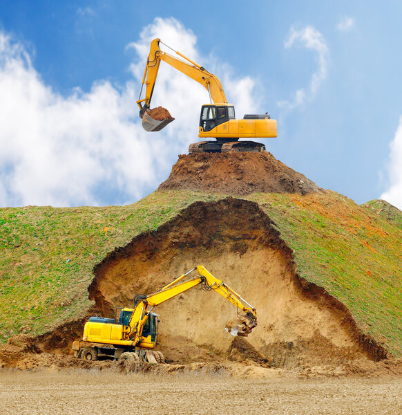 Excavators digging big hole.