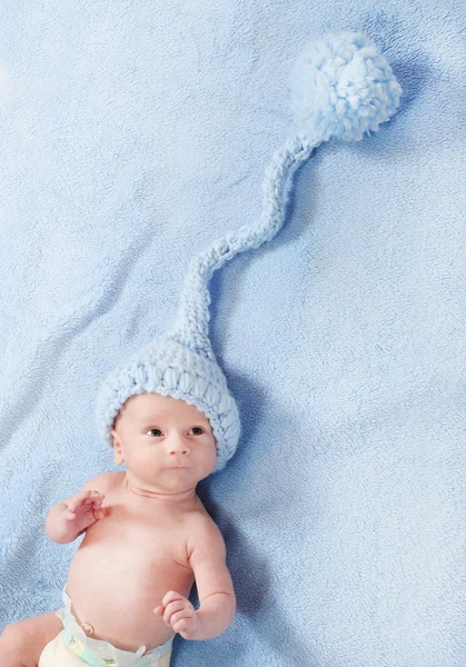 Funny baby boy in blue knitted cap — Stock Photo, Image