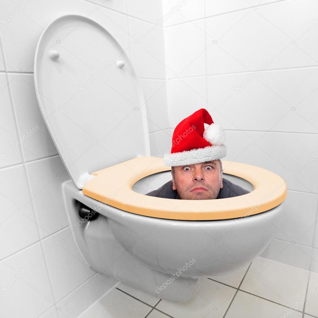 Santa Claus looking from the toilet bowl