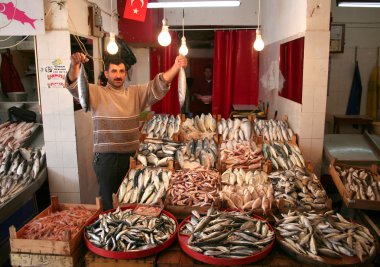Fish Monger Showing his Fish clipart
