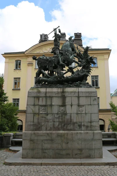 Stockholm, İsveç-18 Eylül 2025: St. George and The Dragon Sculpture with Old Building and Blue Sky Background at Gamla Stan