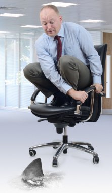 Scared businessman on office chair clipart