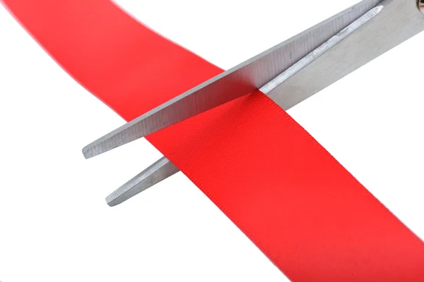 Scissors cutting red ribbon — Stock Photo, Image