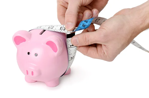 Measuring tape around a piggy bank — Stock Photo, Image